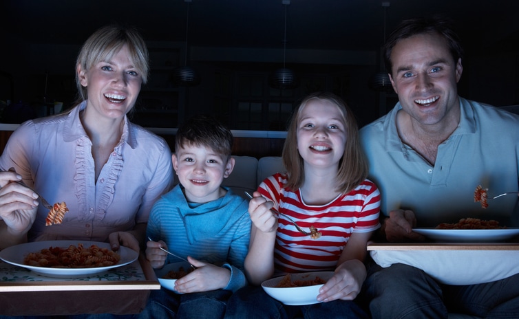 Couple Enjoying Meal Whilst Watching TV