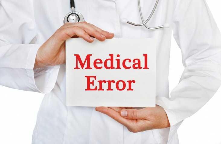 Doctor holding medical error card