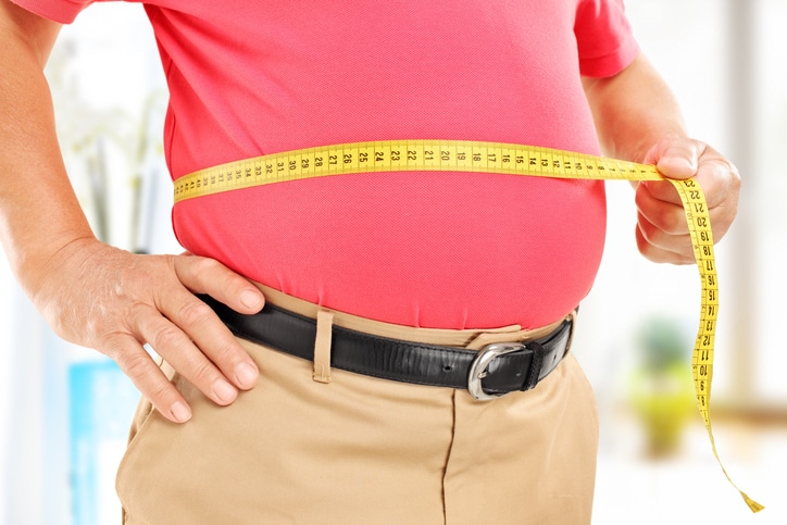 Overweight Male measuring bellyfat