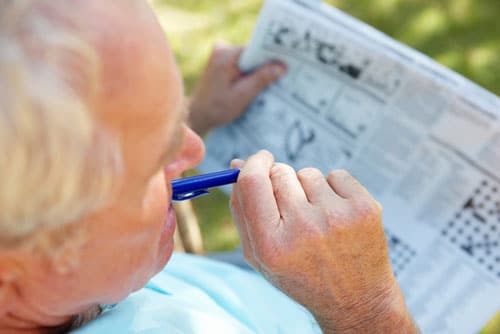 Senior doing crossword puzzle