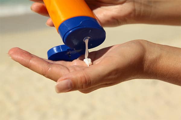 Photo of Woman Holding Sunscreen