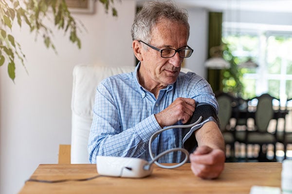 Photo of man taking blood pressure.