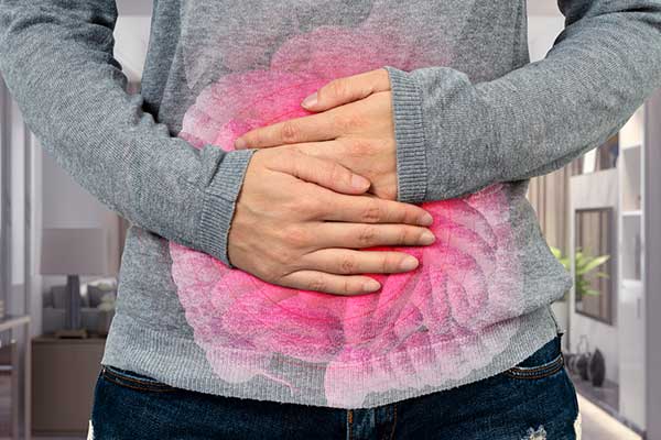Person holding stomach with both hands symbolizing gut pain with pink animated color.
