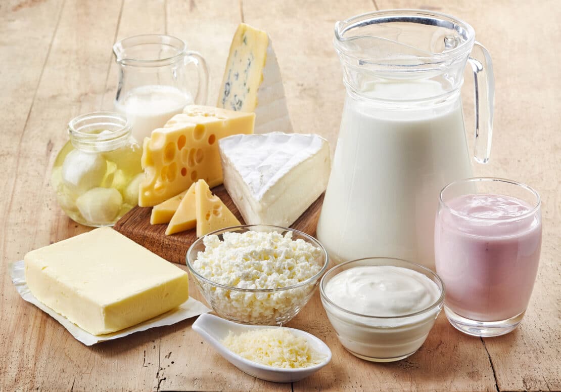 Milk and other dairy products on a table.
